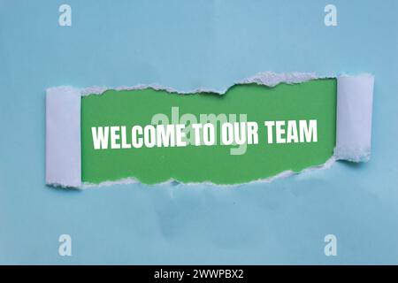 Welcome to our team words written on blue torn paper with green background. Conceptual business symbol. Copy space. Stock Photo