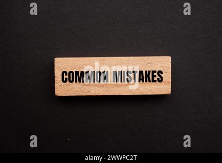 Common mistakes words written on wooden block with black background. Conceptual symbol. Copy space. Stock Photo