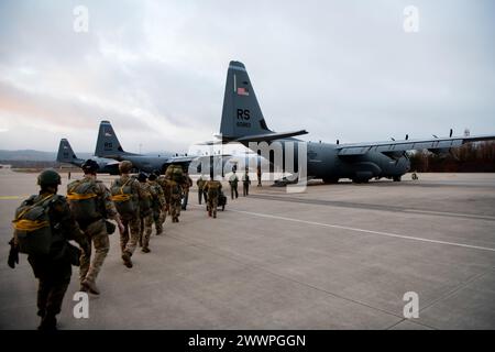 Airmen from the 435th Security Forces Squadron walk to a C-130J Super Hercules on Ramstein Air Base, Germany, on Feb. 13, 2024. The squadron is a part of the 435th Contingency Response Group which is the only expeditionary open-the-base force in the U.S. Air Forces in Europe.  Air Force Stock Photo