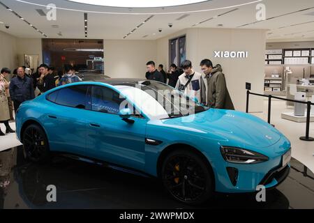 Shanghai,China-March 25th 2024: Xiaomi SU7 electric car in store with Chinese customers Stock Photo