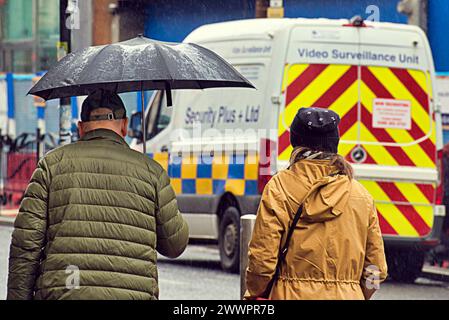 Glasgow, Scotland, UK. 25th March, 2024: UK Weather:  Wet spring weather in the city saw locals and tourists on the streets of the city centre with their umbrellas. Credit Gerard Ferry/Alamy Live News Stock Photo