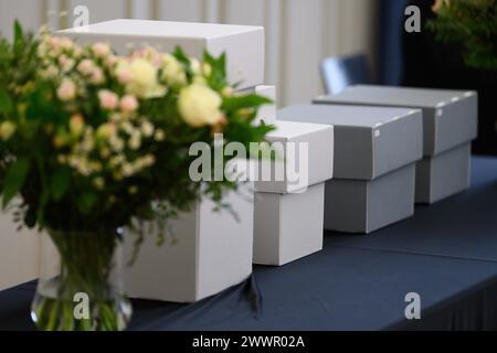 25 March 2024, Lower Saxony, Göttingen: Boxes containing human remains are placed on a table during a ceremony at the University of Göttingen. The University and the State Ethnographic Collections of Saxony return human remains to the Republic of Palau. Photo: Swen Pförtner/dpa Stock Photo