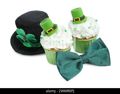 St. Patrick's day party. Tasty festively decorated cupcakes, green bow tie and leprechaun hat, isolated on white Stock Photo