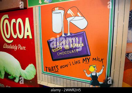 Vintage replica Cadbury's Dairy Milk Advertising signs of their chocolate products on display at the Cadbury's factory  and offices in Bournville, Bir Stock Photo
