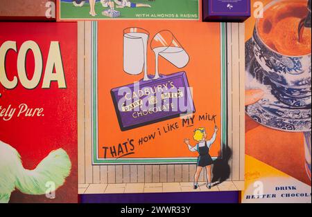 Vintage replica Cadbury's Advertising signs of their chocolate products on display at the Cadbury's factory  and offices in Bournville, Birmingham. Stock Photo