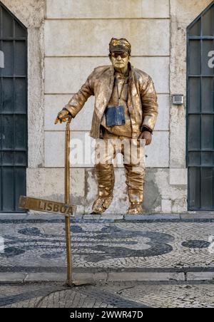 Living statue male in gold in Lisbon, Portugal Stock Photo
