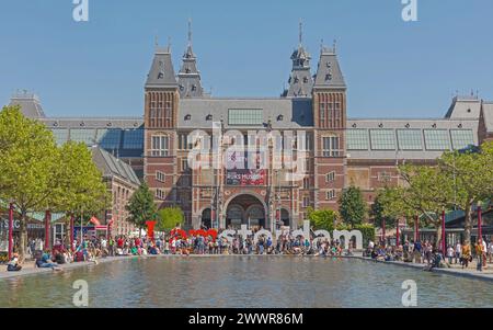 Amsterdam, Netherlands - May 15, 2018: Bunch of People in Front of Rijksmuseum Dutch National Museum of Arts and History View Over Pond. Stock Photo