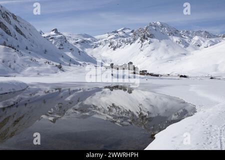 The Rochers de la Petite Balme, the Grande Motte and the Grande Casse dominate the Val Claret district, all reflected in the lake at Tignes, France. Stock Photo