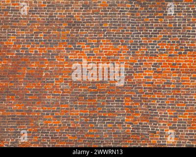 Big wall made of orange and grey bricks Stock Photo