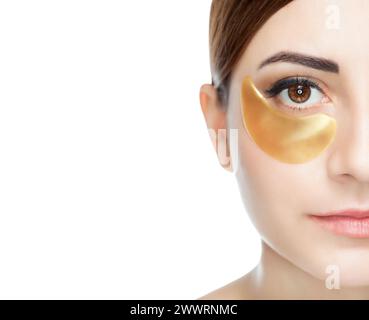 Collagen gold patches on the skin of the eyelid, on the face of a beautiful woman. Stock Photo