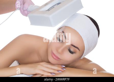 The cosmetologist uses the Wood Lamp for detailed diagnosis of the skin condition. The device detects the presence of skin diseases or inflamed areas. Stock Photo