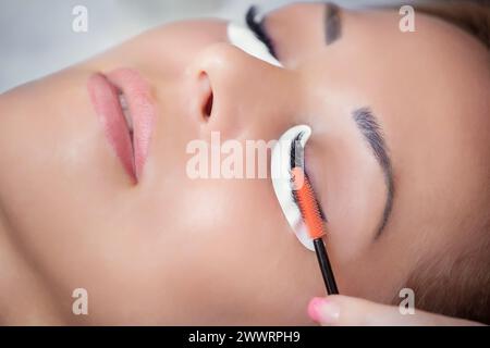 Beautiful Woman with long eyelashes in a beauty salon. Eyelash extension procedure. Lashes close up Stock Photo