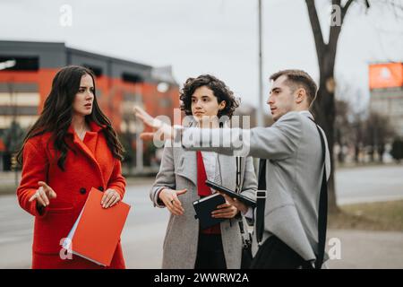 Business associates discussing strategy outdoors with serious expressions Stock Photo