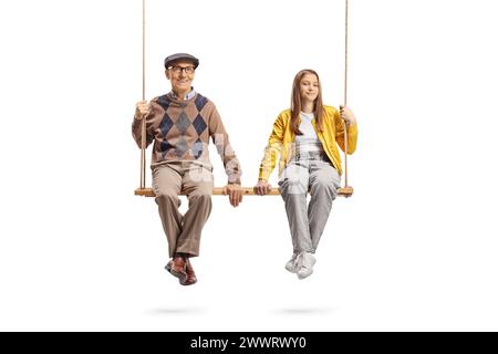 Grandfather and teenage granddaughter sitting together on a big wooden swing isolated on white background Stock Photo