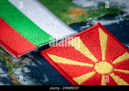 Bulgaria and Macedonia flags patches and country symbols on globe background, Close up, Concept of difficult mutual relations Stock Photo