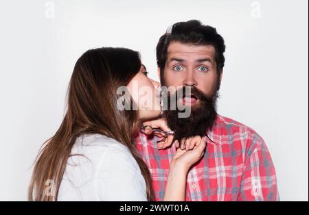 Funny couple shaving. Barbershop beard care. Bearded man getting haircut by hairdresser. Barber scissors and straight razor. Stock Photo