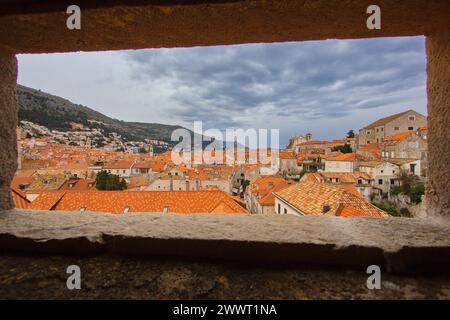 View through the fort window to the rooftop of Old town in Dubrovnik, Dalmatia, Croatia. Stock Photo