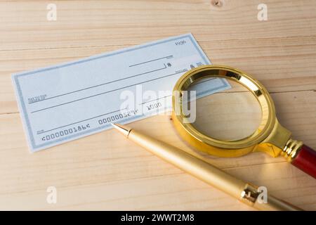 Banking Check with magnifier glass Stock Photo