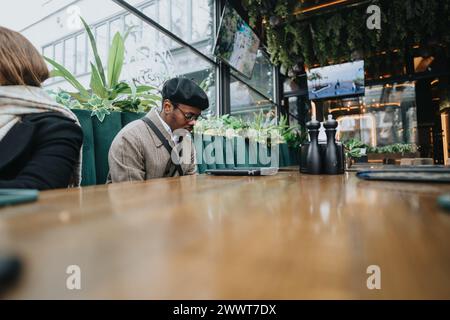 Young business professionals working on laptop in stylish urban coffee shop Stock Photo
