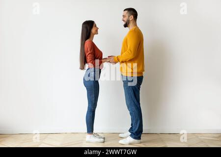 Two people holding hands with blurred faces Stock Photo