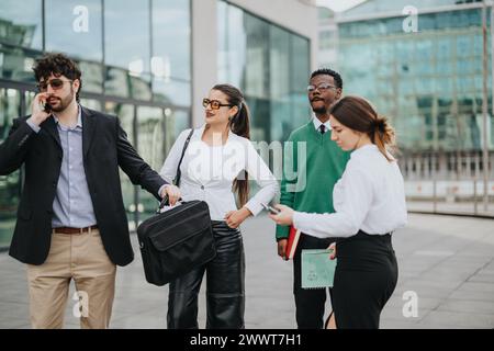 Young startup colleagues engaging in an outdoor business meeting in an urban setting Stock Photo