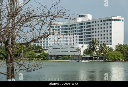 Cartagena, Colombia - July 25, 2023: Central Bocagrande. Hilton hotel closeup on south side of El Laguito laguna with greenish water and green foliage Stock Photo