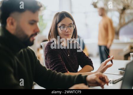 Successful collaboration of multinational business team analyzing statistics and brainstorming ideas. Stock Photo