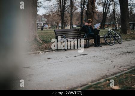 Business professional taking a break in the park with a bicycle Stock Photo