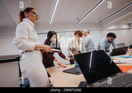 Multiethnic business team collaborating on strategic sales strategy for profit growth in a corporate training workshop. Stock Photo