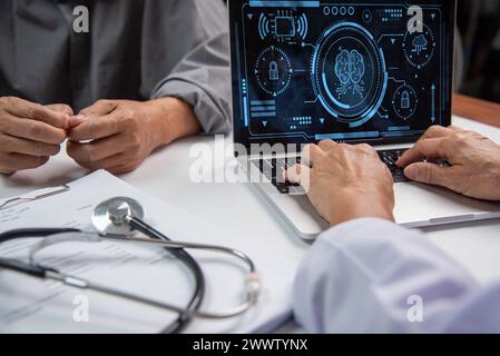 Doctor healthcare worker examines data analysis brain advanced software on a laptop, with a stethoscope and medical documents on the desk. Stock Photo
