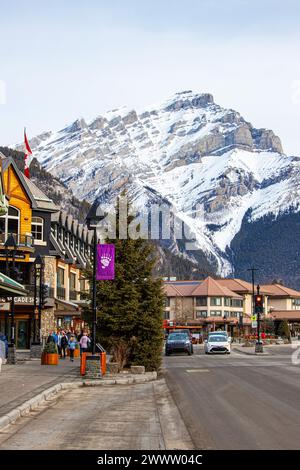 BANFF, CANADA - FEBRUARY 22, 2024: Majestic Cascade Mountain looms over Banff Avenue in the Banff National Park. The townsite is a major Canadian tour Stock Photo
