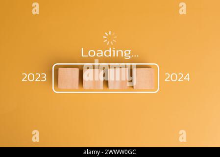 loading progress 2024 wood cube count down on background. Stock Photo