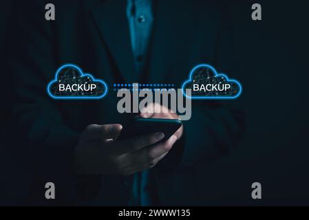 Businessman Interacting with a Backup Interface virtual cloud network data security system internet online with futuristic holographic digital technol Stock Photo