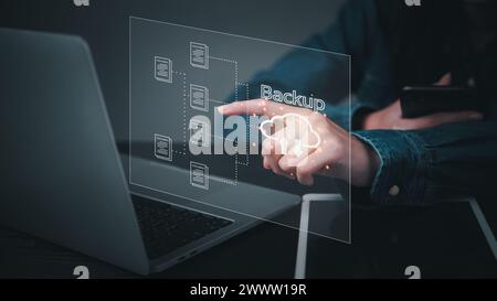 Businessman Interacting with a Backup Interface virtual cloud network data security system internet online with futuristic holographic digital technol Stock Photo