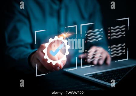 person holds a glowing check mark symbol, representing approval, confirmation, or successful verification of quality control. data business service as Stock Photo
