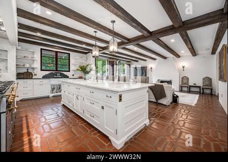 Spacious home interior with open kitchen and living room, featuring exposed ceiling Stock Photo