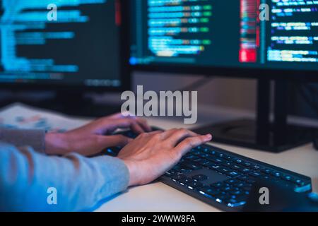 close up hand  developer devops  coding software data working  at night in office Stock Photo