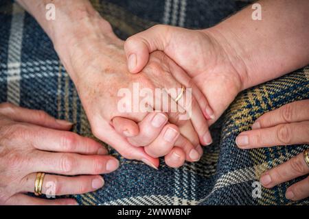 Two People Holding Hands; UK Stock Photo