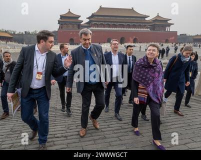 Peking, China. 26th Mar, 2024. Markus Söder (M, CSU), Minister President of Bavaria, visits the historic Forbidden City in the Chinese capital. Söder is traveling to the People's Republic of China until 28.03.2024. He is accompanied by the German ambassador to China, Patricia Flor (r). Dominic Hosner (l) from the German Archaeological Institute in Beijing explains the site to them. Credit: Peter Kneffel/dpa/Alamy Live News Stock Photo