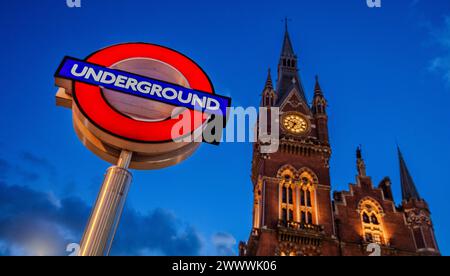 Underground Sign for Kings Cross underground station with the clock tower of Paddington Station in London Stock Photo