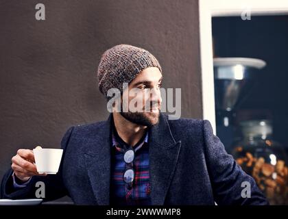 Thinking, cafe and serious man drinking coffee for breakfast at cafeteria or restaurant in the morning. Dream, tea cup and person with espresso, latte Stock Photo