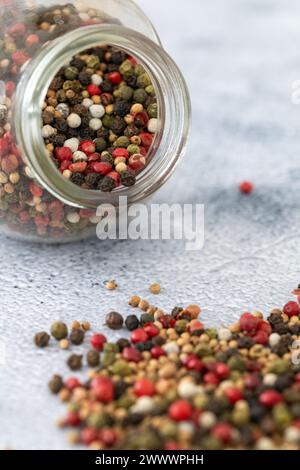 Colorful pepper and corriander spicy mix in jar on the table Stock Photo