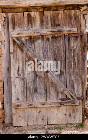 old door made of wooden planks, with iron hinges and locks, beautiful wood textures Stock Photo
