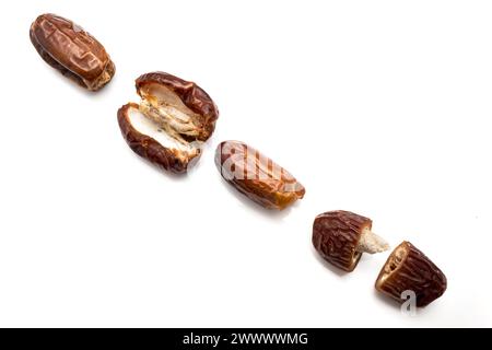 Image of tasty dried dates fruits isolated on white background. Clipping path. Vegetarian and healthy snack. Stock Photo