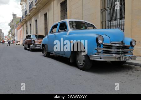 106 Blue Plymouth Special DeLuxe 1949, Chevrolet Bel Air 1957, American hard-top sedan 4-door classic cars parked on a street of Centro Havana-Cuba. Stock Photo