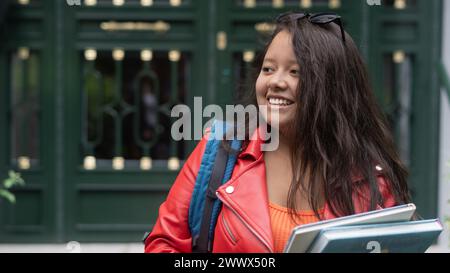 happy young student walking with books and bag Stock Photo