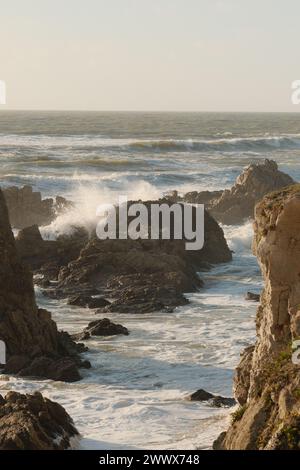 The ocean waves hitting rocks along the coast Stock Photo - Alamy