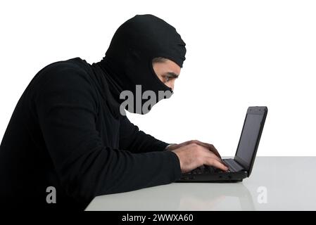 Hidden hacker works in the dark to steal data online Stock Photo