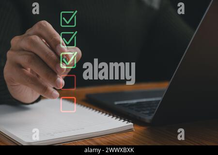 Checklist concept, business person checklist tick answer sign in checkbox, validation online questionnaire quality control document, man use pen to ti Stock Photo