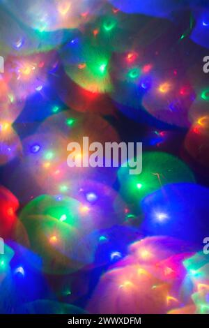 Out of focus Christmas lights, colourful with flare Stock Photo